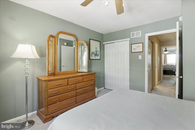 bedroom with attic access, visible vents, baseboards, a closet, and light carpet