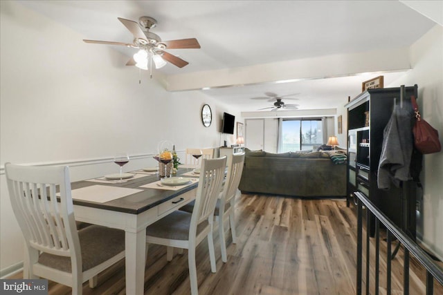 dining area featuring ceiling fan and wood finished floors