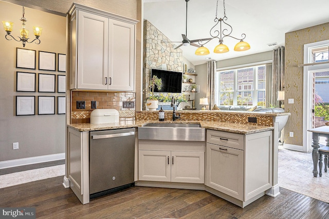 kitchen with a sink, dark wood-style flooring, ceiling fan with notable chandelier, and dishwasher