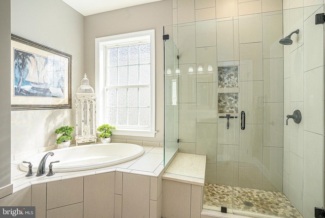 bathroom featuring a stall shower and a bath
