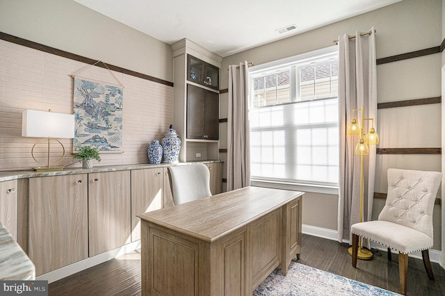 home office with baseboards, visible vents, and dark wood-type flooring