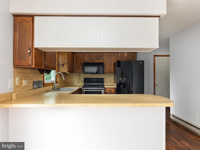 13970 Back Rd, Strasburg, VA 22657 - kitchen with black appliances, a sink, a baseboard heating unit, light countertops, and a peninsula