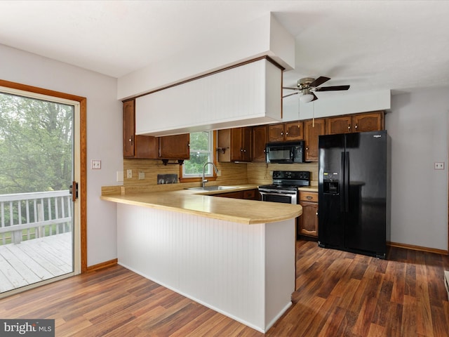 13970 Back Rd, Strasburg, VA 22657 - kitchen with black appliances, light countertops, a peninsula, and dark wood-style flooring