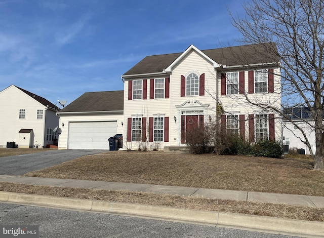 40 Browning Cir, Middletown, DE 19709 - colonial-style house featuring driveway, an attached garage, and a front lawn