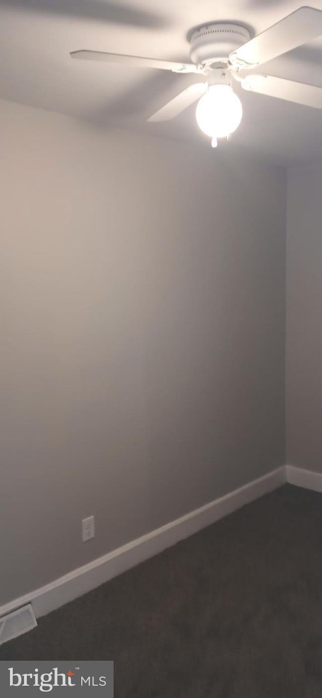 empty room featuring baseboards and ceiling fan