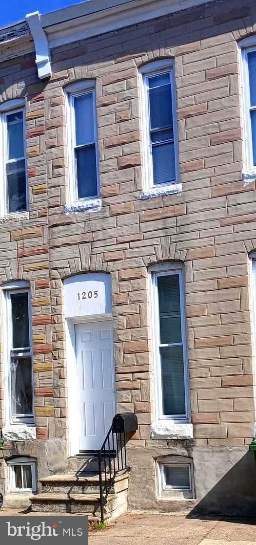 doorway to property with stone siding