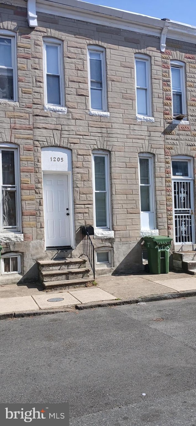 view of property featuring stone siding