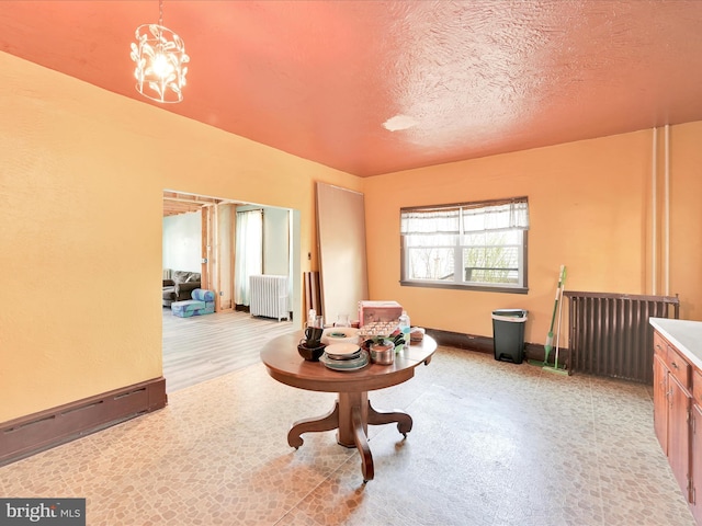 misc room with a textured ceiling and radiator heating unit