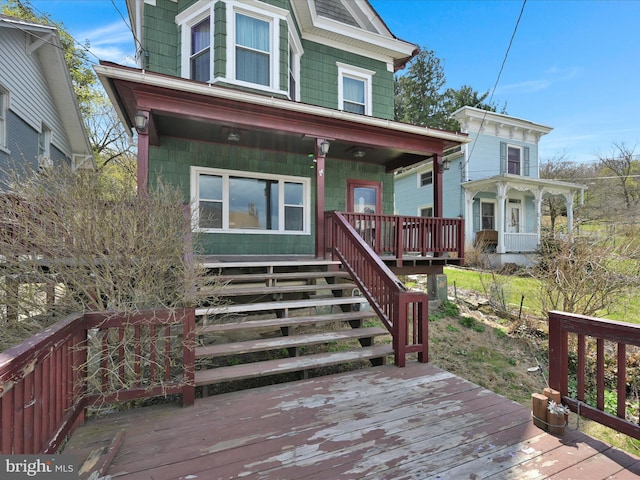 view of front of property with a porch and stairway