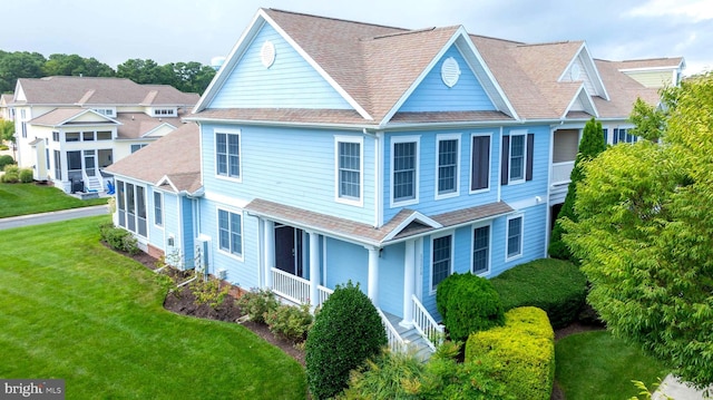 view of front of property with a porch and a front lawn