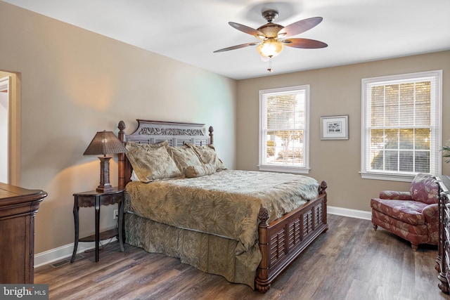 bedroom featuring baseboards, ceiling fan, and wood finished floors