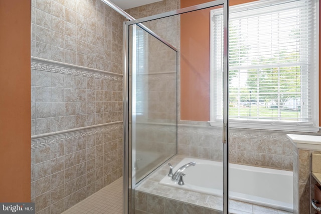 bathroom with a garden tub and a shower stall