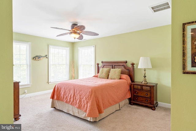 carpeted bedroom featuring baseboards, multiple windows, and visible vents