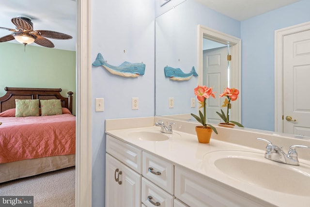 full bathroom with double vanity, a sink, ceiling fan, and ensuite bath