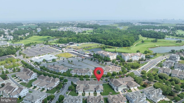 birds eye view of property featuring a water view, view of golf course, and a residential view