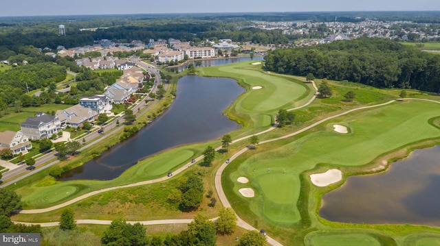 birds eye view of property featuring a water view, view of golf course, and a residential view