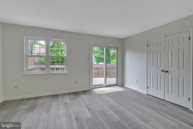 431 Eagle Rd Unit 16, Wayne, PA 19087 - unfurnished bedroom with access to outside, light wood-style floors, and a closet