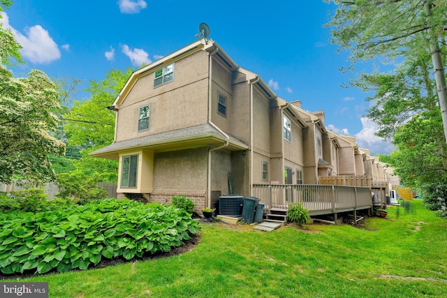 431 Eagle Rd Unit 16, Wayne, PA 19087 - back of house with stucco siding, a wooden deck, a lawn, and brick siding