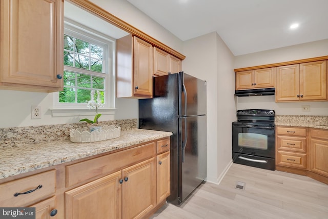 431 Eagle Rd Unit 16, Wayne, PA 19087 - kitchen with black appliances, under cabinet range hood, light wood-style floors, light stone counters, and light brown cabinets