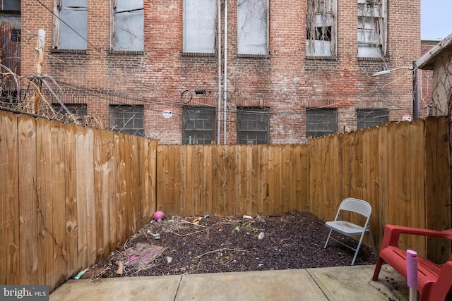 view of patio / terrace featuring fence