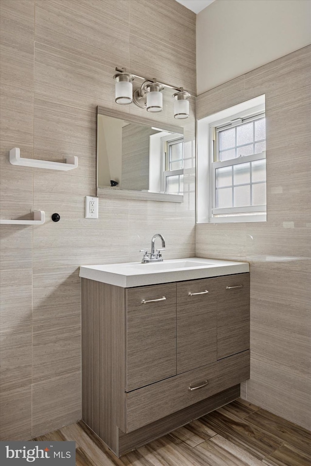 bathroom featuring tile walls, tasteful backsplash, and vanity