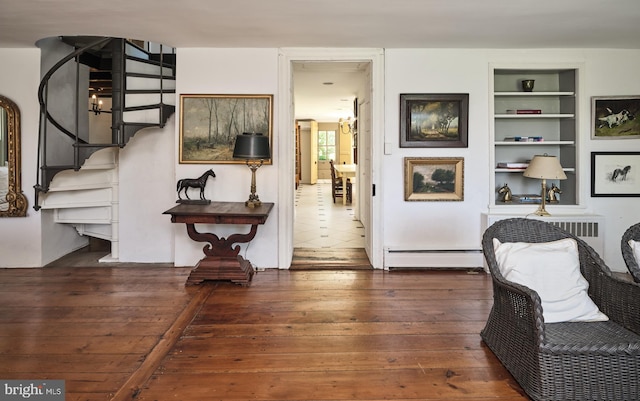 4273 Durham Rd, Kintnersville, PA 18930 - living area featuring built in shelves, hardwood / wood-style floors, stairway, and baseboard heating