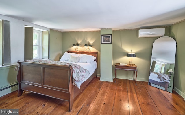 4273 Durham Rd, Kintnersville, PA 18930 - bedroom with an AC wall unit, arched walkways, hardwood / wood-style floors, baseboards, and a baseboard heating unit
