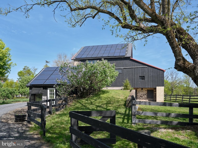 4273 Durham Rd, Kintnersville, PA 18930 - exterior space with a lawn, fence, roof mounted solar panels, and gravel driveway