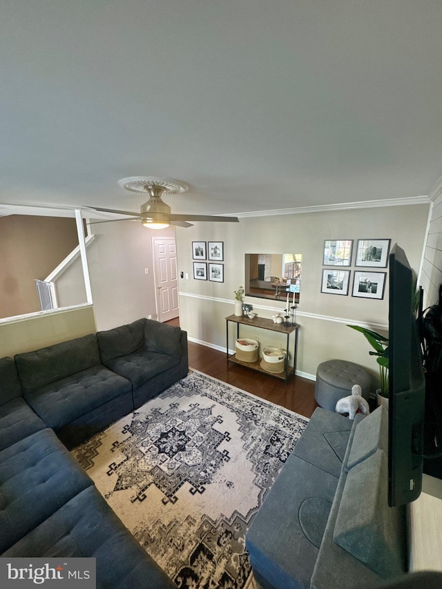 living area with crown molding, baseboards, ceiling fan, and wood finished floors