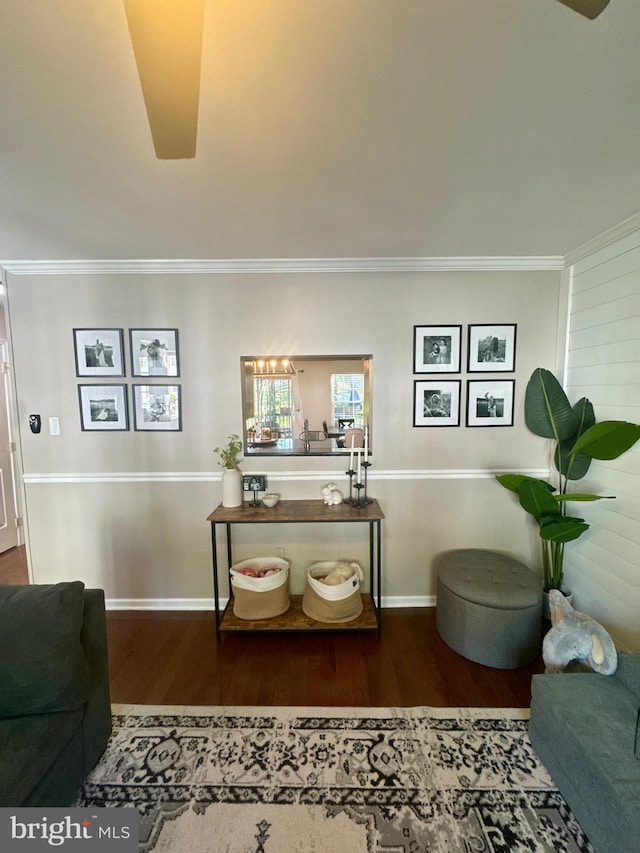 interior space with crown molding and wood finished floors