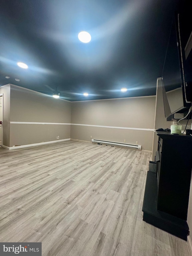 below grade area with recessed lighting, baseboards, wood finished floors, and baseboard heating
