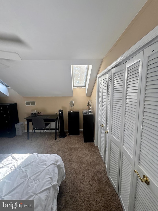 bedroom with visible vents, carpet flooring, baseboards, and vaulted ceiling with skylight