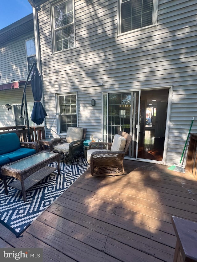 wooden terrace featuring outdoor lounge area