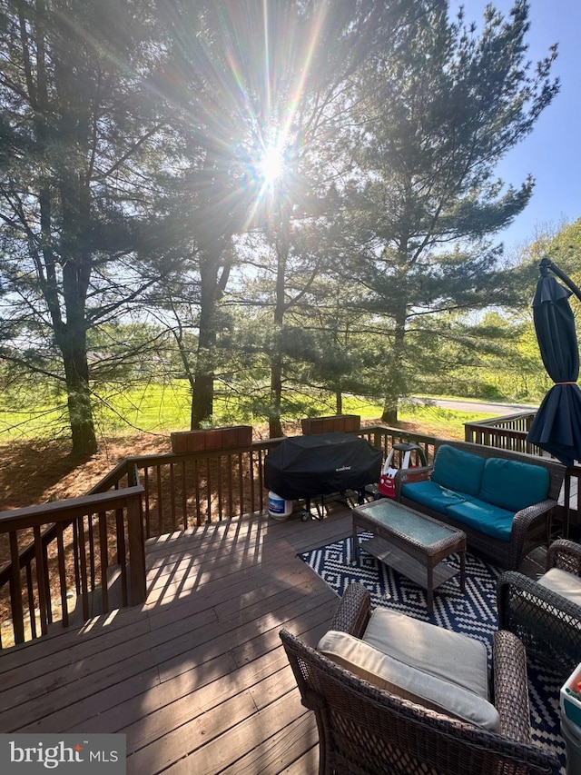 wooden deck featuring outdoor dining space and grilling area