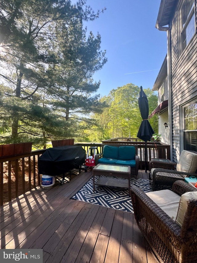 wooden terrace with an outdoor hangout area
