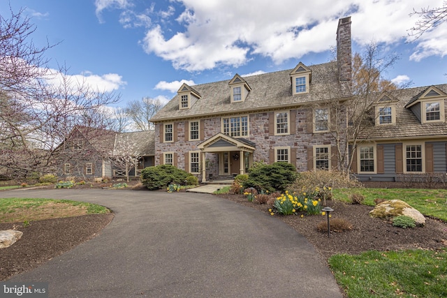 colonial inspired home featuring a chimney