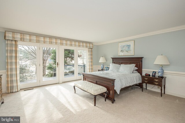 bedroom with visible vents, ornamental molding, light carpet, and access to exterior