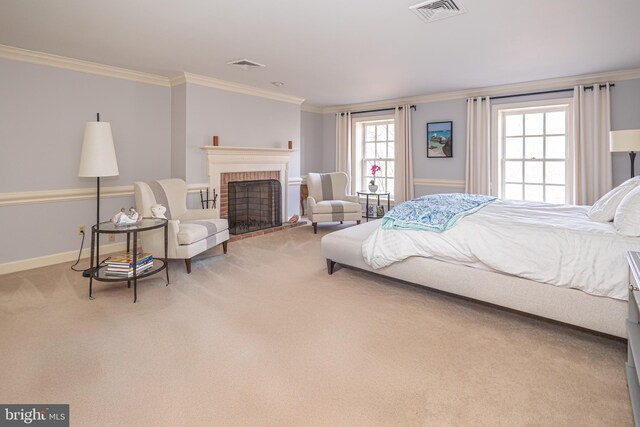 carpeted bedroom featuring visible vents, baseboards, crown molding, and a fireplace