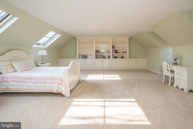 bedroom with light colored carpet and lofted ceiling with skylight
