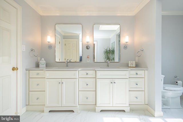 full bath featuring double vanity, a sink, toilet, and ornamental molding