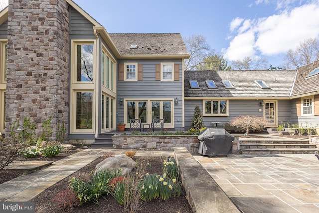 rear view of property featuring french doors and a patio