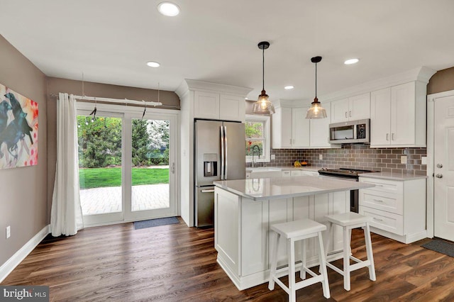 kitchen with light countertops, appliances with stainless steel finishes, and white cabinets