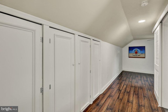 hallway featuring recessed lighting, baseboards, vaulted ceiling, and dark wood-style floors