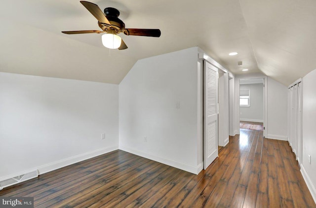 additional living space featuring ceiling fan, visible vents, hardwood / wood-style flooring, baseboards, and lofted ceiling