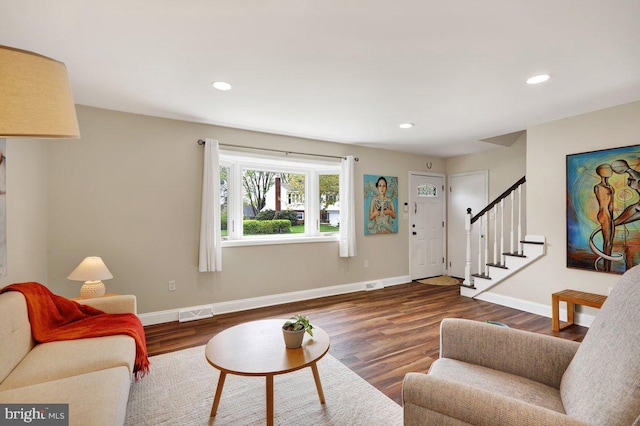 living room with visible vents, wood finished floors, stairway, baseboards, and recessed lighting
