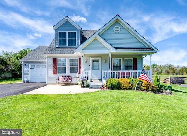 view of front of home with a shingled roof, an attached garage, a front lawn, aphalt driveway, and covered porch