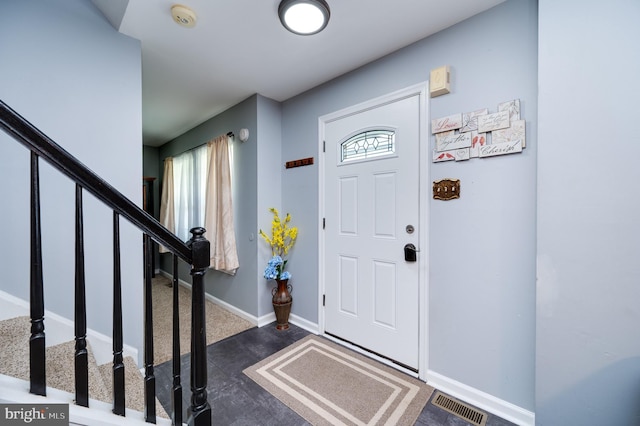 entryway featuring a healthy amount of sunlight, baseboards, stairs, and visible vents