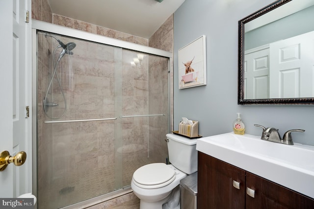 full bath with vanity, toilet, and a shower stall