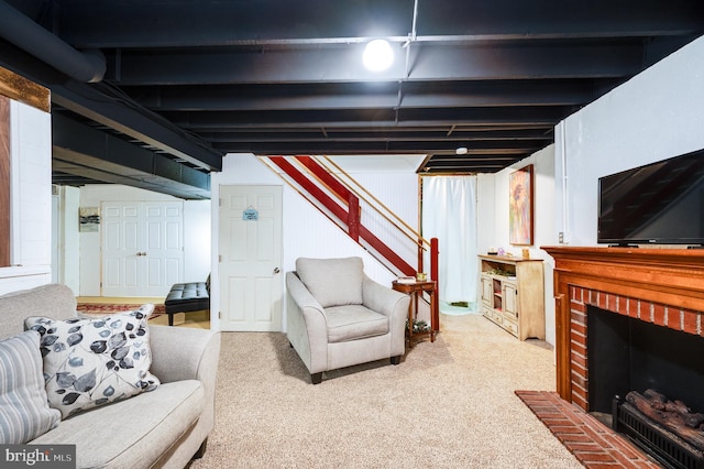 carpeted living room featuring a brick fireplace