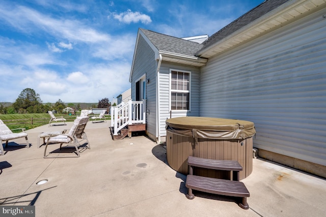 view of patio / terrace with a hot tub